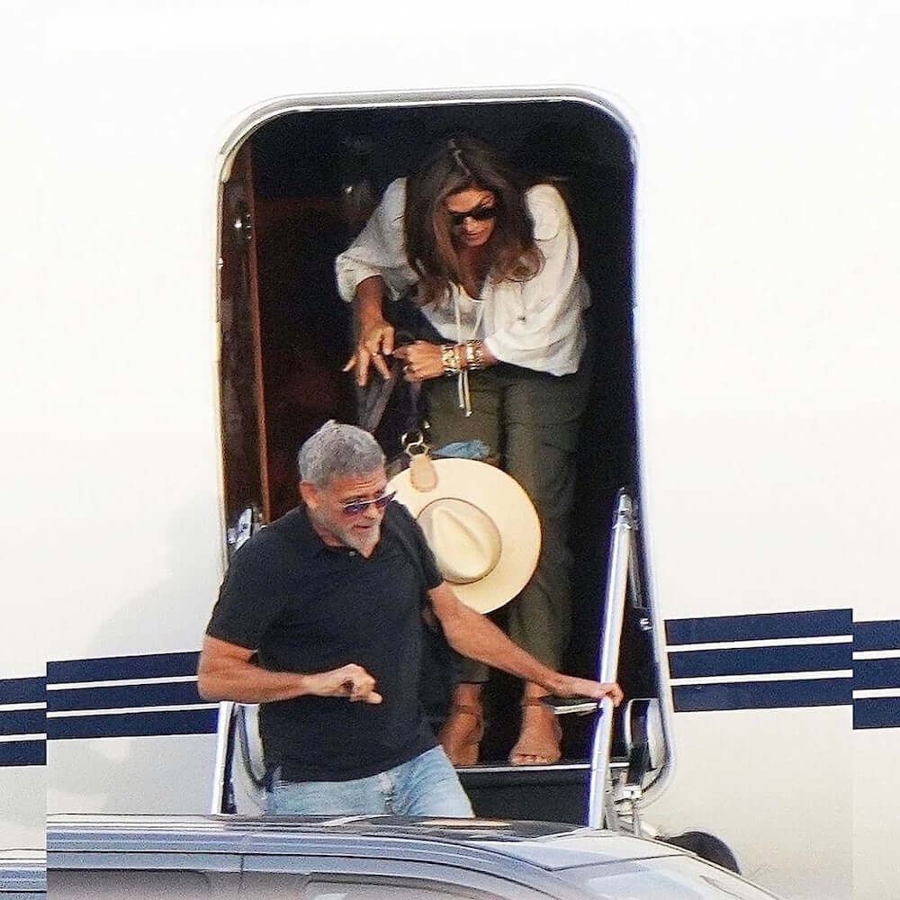 Cindy Crawford stylishly deplaning from a private jet, showcasing the TOPTOTE hat clip in France.