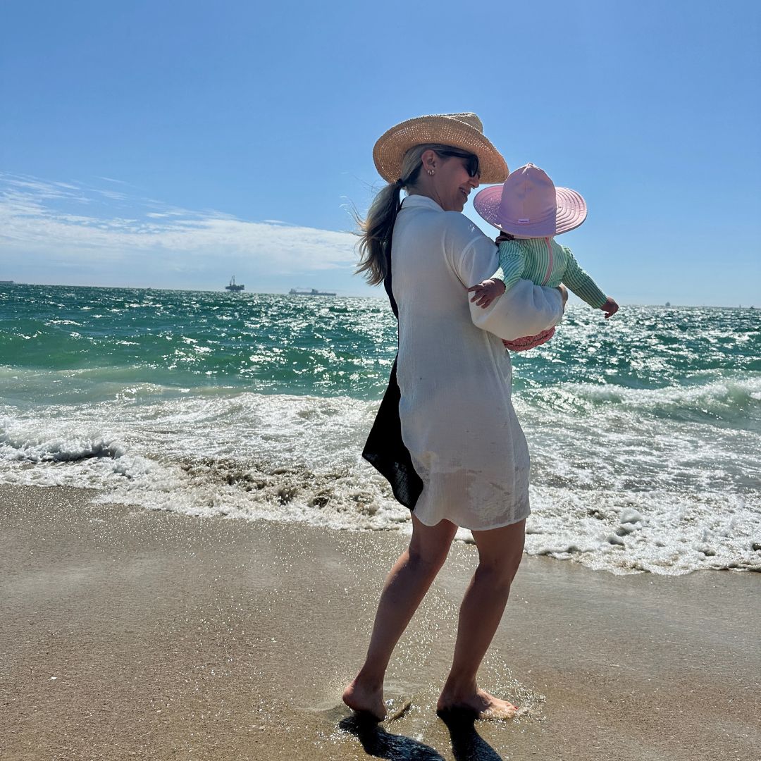 6 Months Postpartum - My 6 Takeaways: Lindsay Albanese and child enjoying a sunny day at the beach.