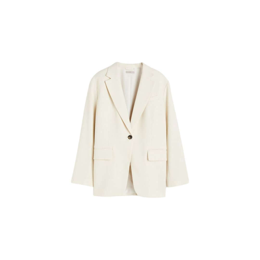 Elegant cream blazer with a relaxed fit and pockets, perfect for professional or casual outfits.
