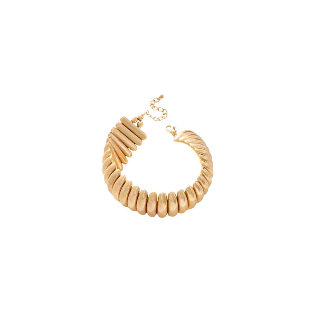 Elegant gold statement bracelet with twisted design, perfect for adding a touch of luxury to any outfit.