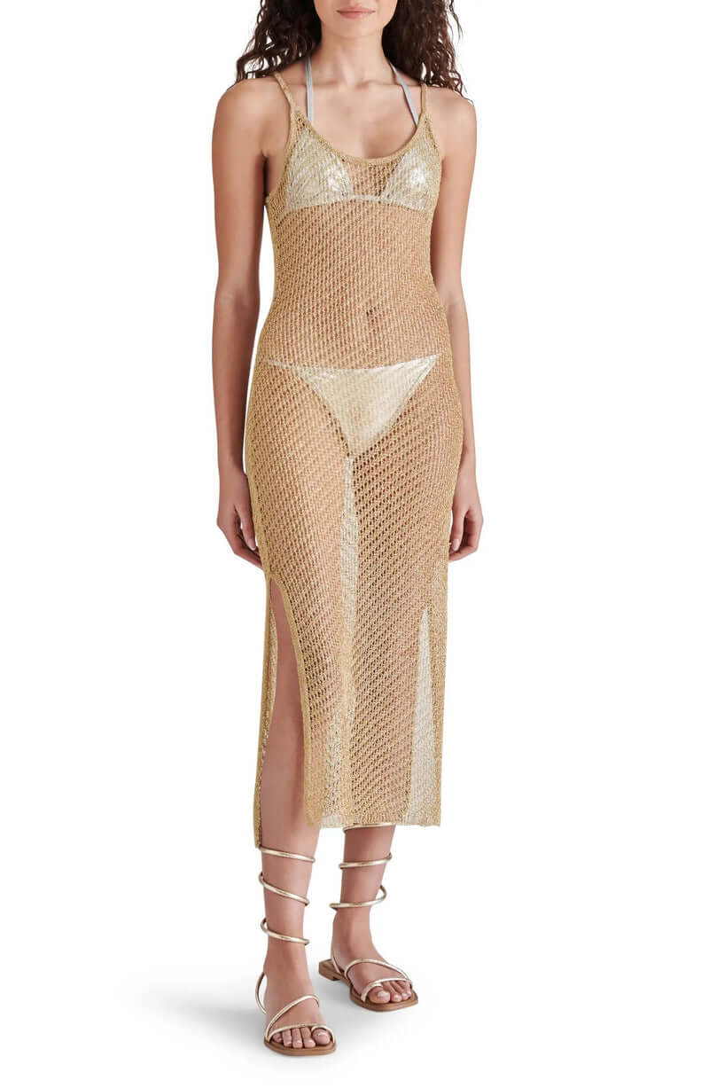 Model wearing a stylish sheer gold knit dress with side slits, perfect for beach or resort wear.