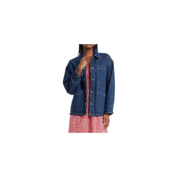 Woman wearing a stylish blue denim jacket over a floral dress, showcasing a trendy casual look.