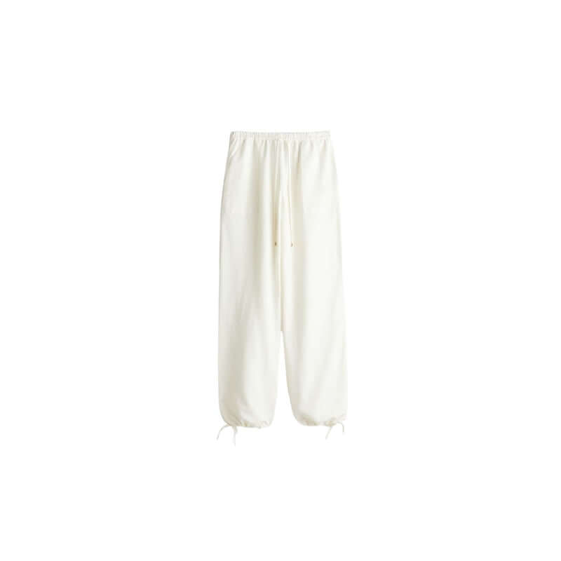 White sweatpants with a comfortable elastic waistband and adjustable drawstrings, perfect for casual wear.