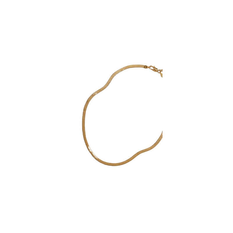 Elegant gold necklace with a wavy design, perfect for adding a touch of sophistication to any outfit.