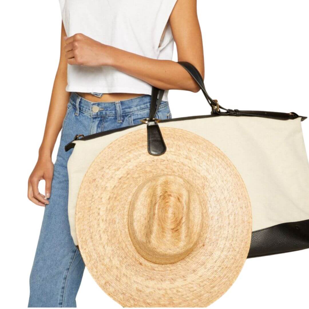 magnetic TOPTOTE Hat Clip in black with gold clasp attached to luggage designed for securely carrying hats hands-free