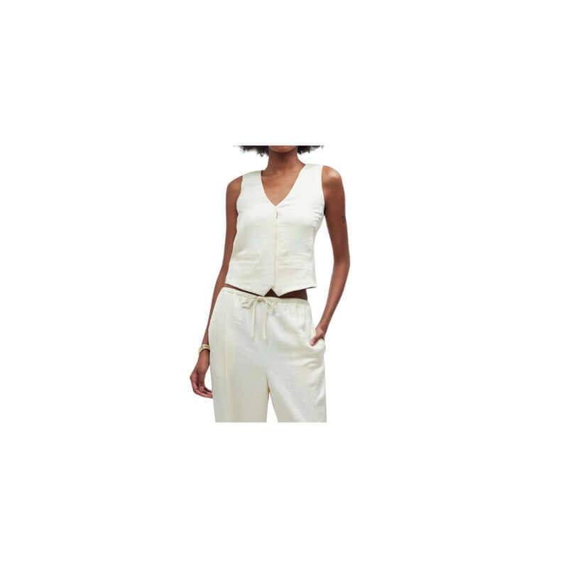 Chic women's ivory vest paired with matching trousers for a stylish summer outfit.