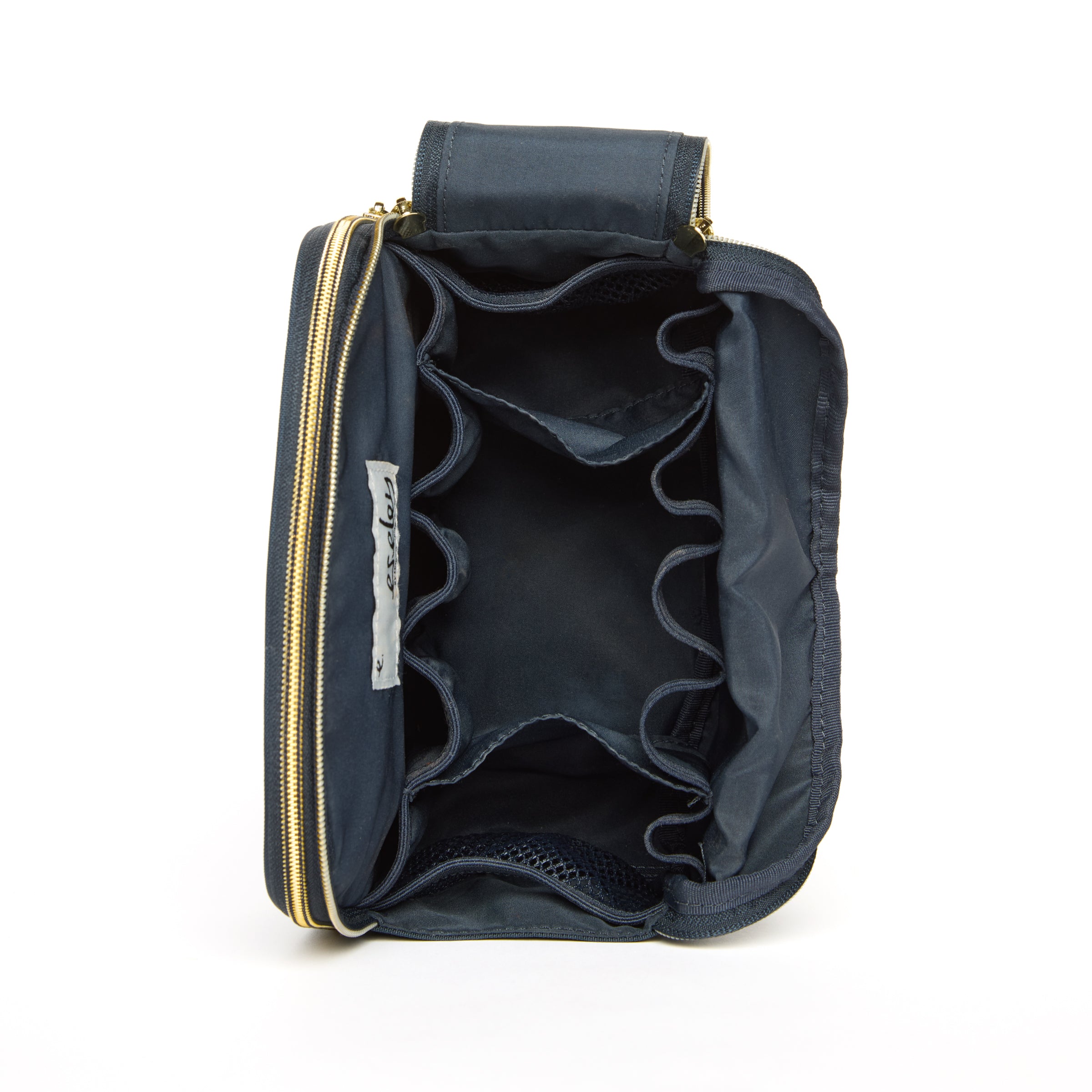 Navy blue bag with gold zipper on a white background open to show all compartments.