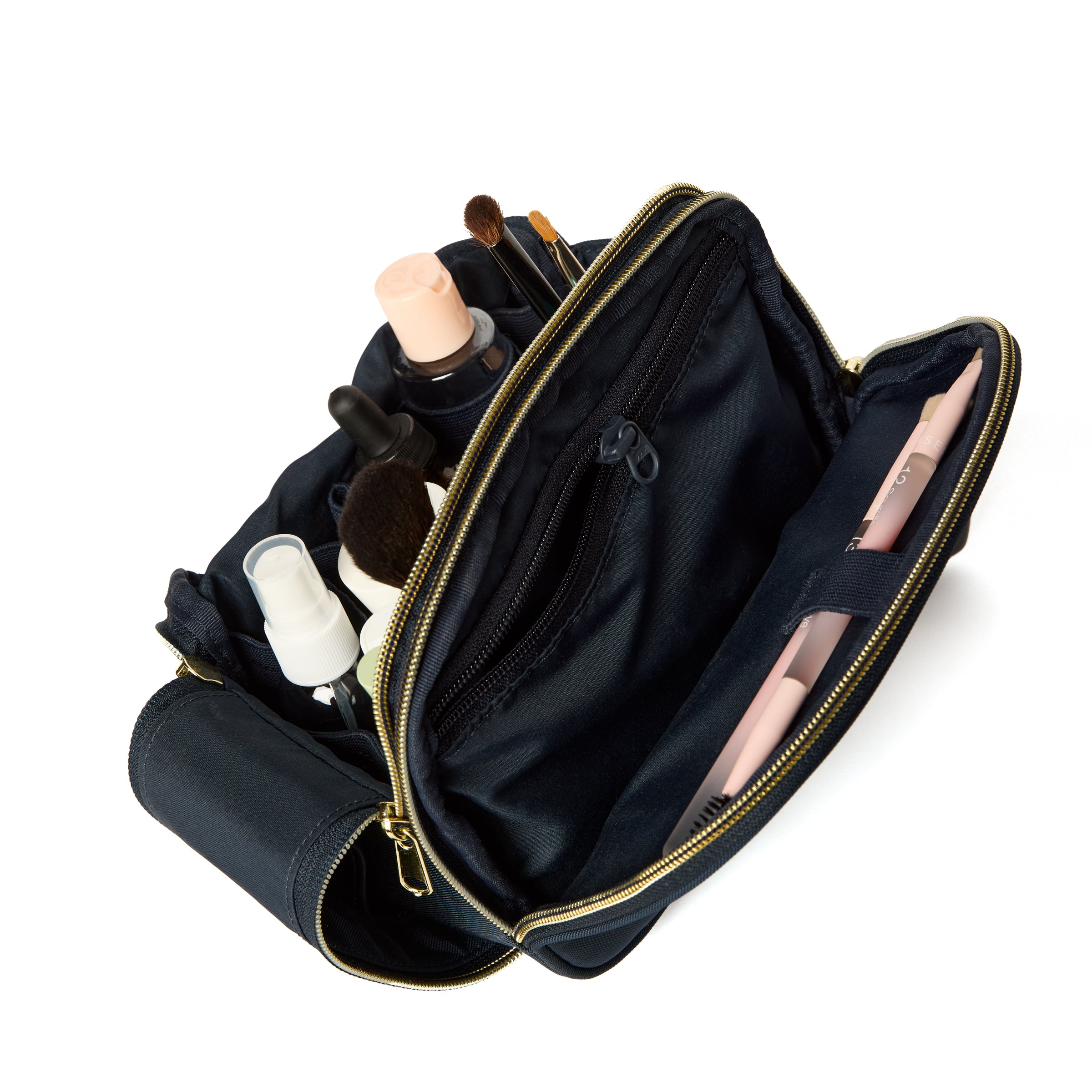 Open navy makeup bag with cosmetic items on a white background