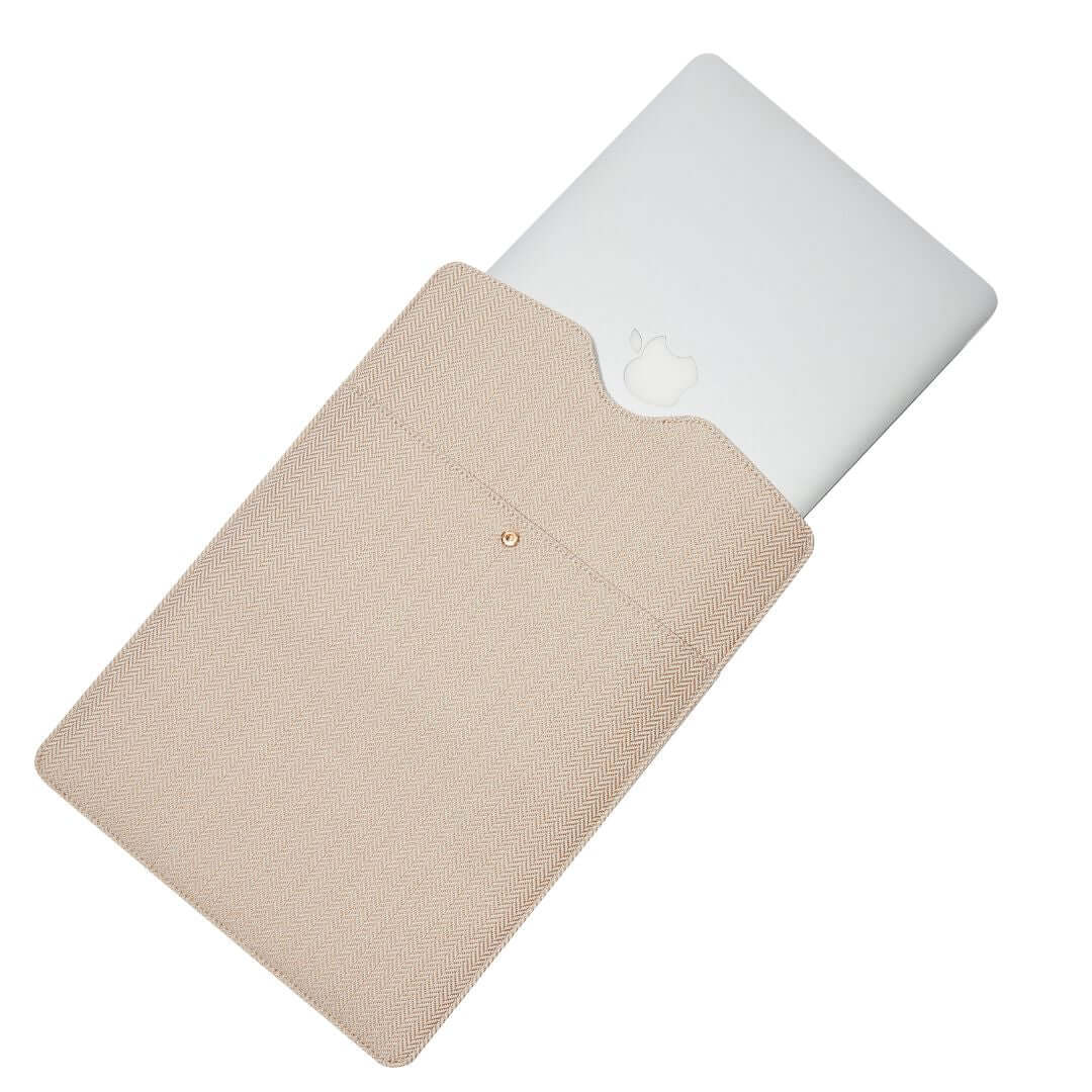 Beige Laptop Clutch by Lindsay Albanese in collaboration with fabfitfun and a laptop.