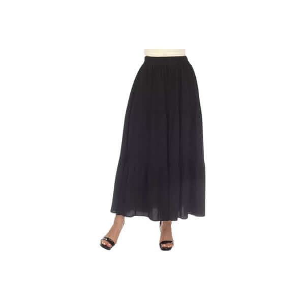 Elegant black maxi skirt with a ruffled hem and high waist, styled with stylish black heels.